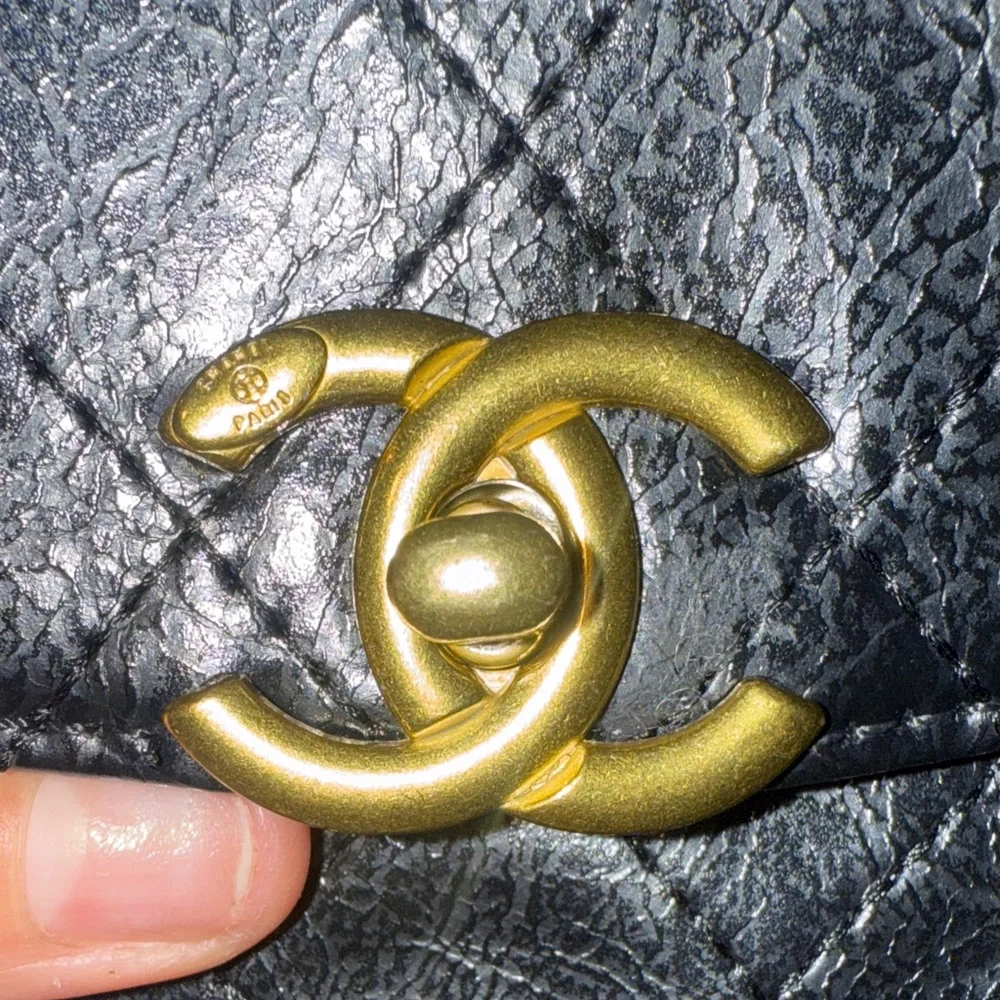 CHANEL Black Quilted Mini Bag with Gold Accents